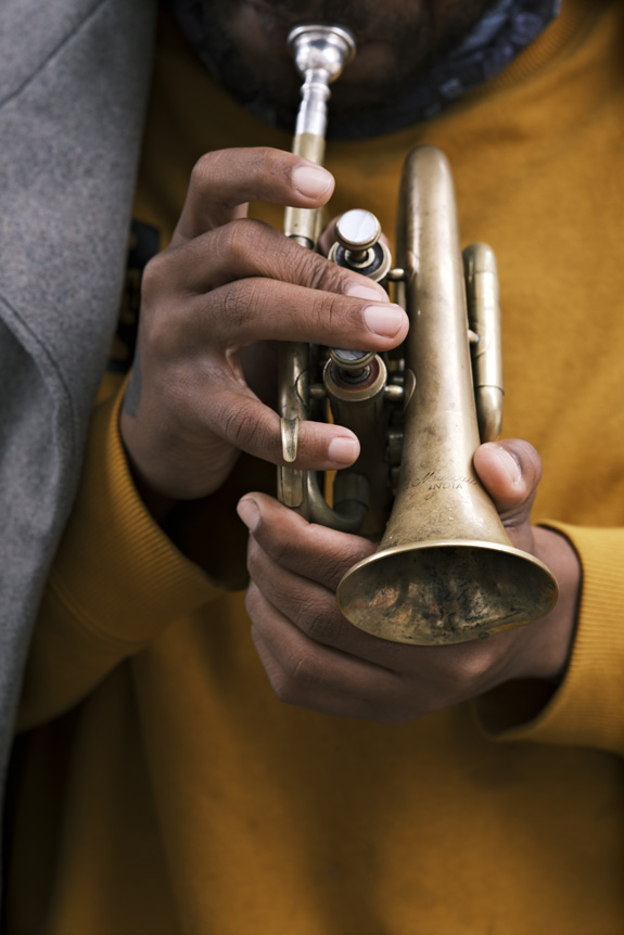 Close up of hands playing mini trumpet