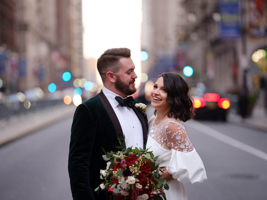 Professional photographer, Alison Conklin, on why the FUJIFILM GFX system is so good for location portrait photography. Image shows a bride and groom on their wedding day posing on a city street.