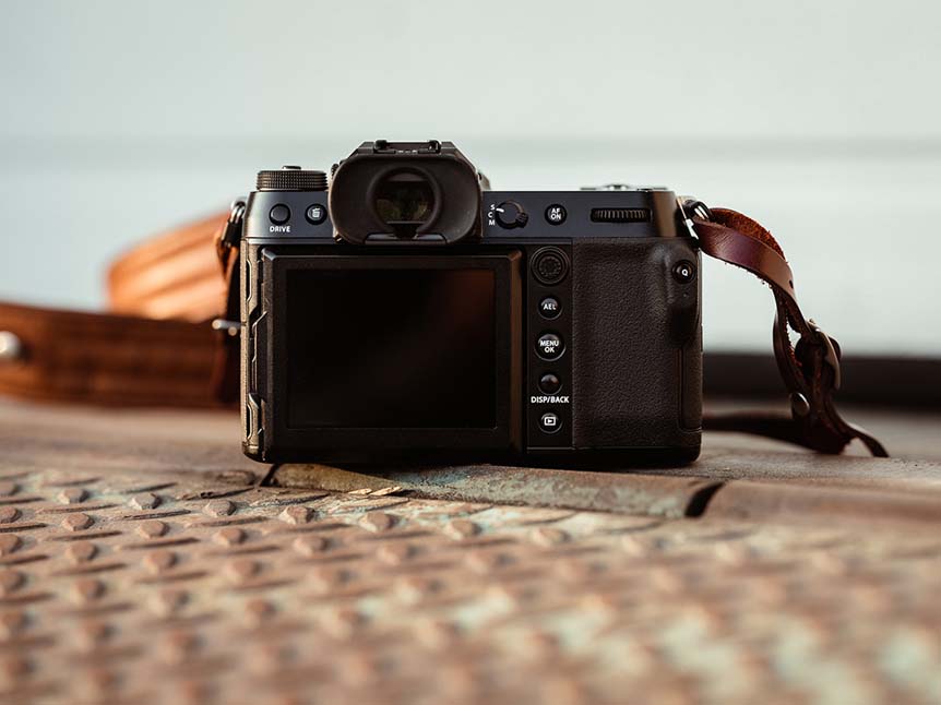 Back of FUJIFILM GFX50R camera on rusted metal ledge