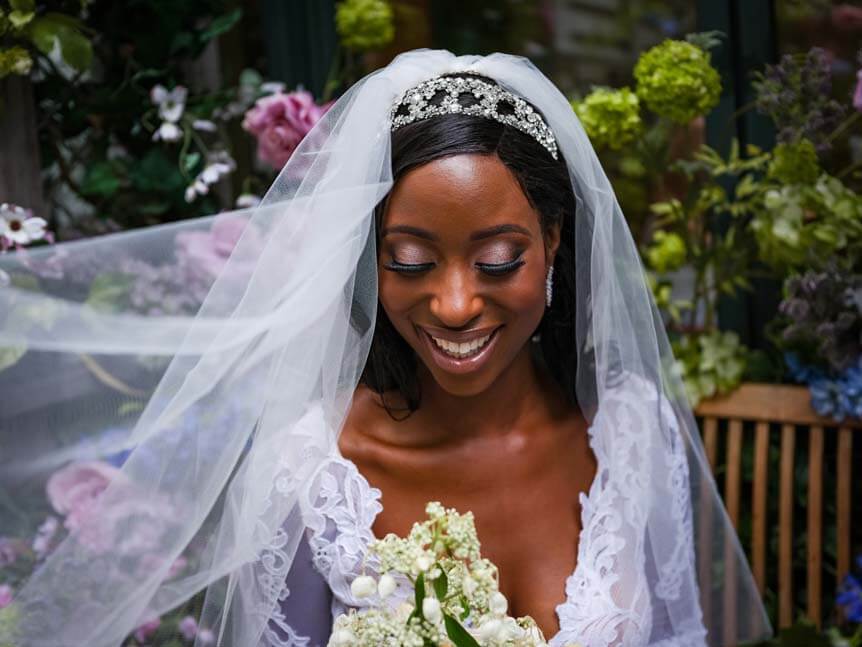 Bride in white veil smiling