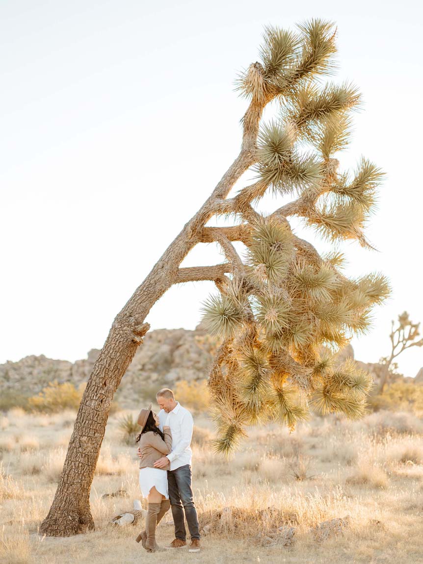 Man and woman beneath desert tree