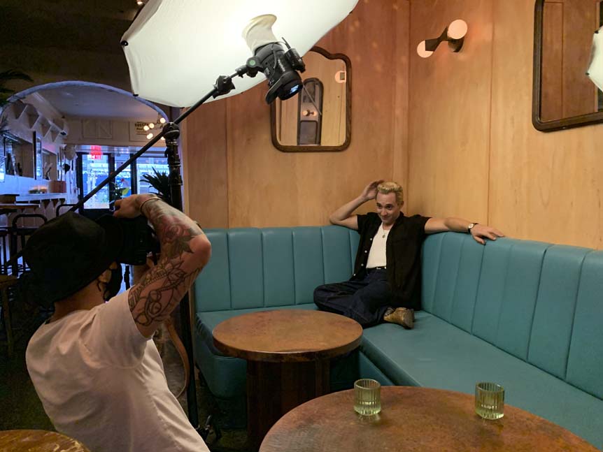Man photographing male model in vintage-style booth