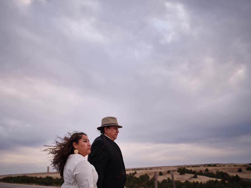 A Native American couple wander through Badlands national park