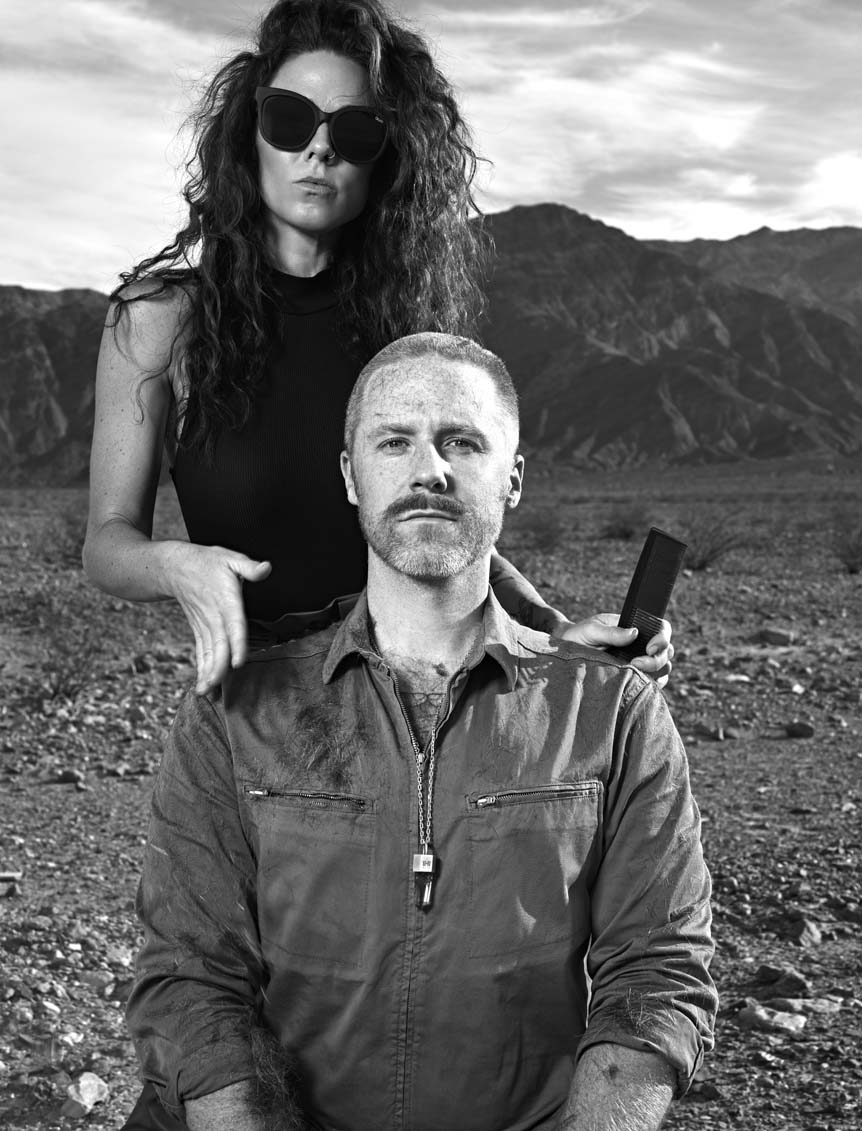 Cast in sinister shades of black & white, a man gazes intently at the camera, following a haircut in Death Valley