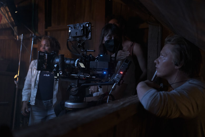 Crew surrounding camera in dark room
