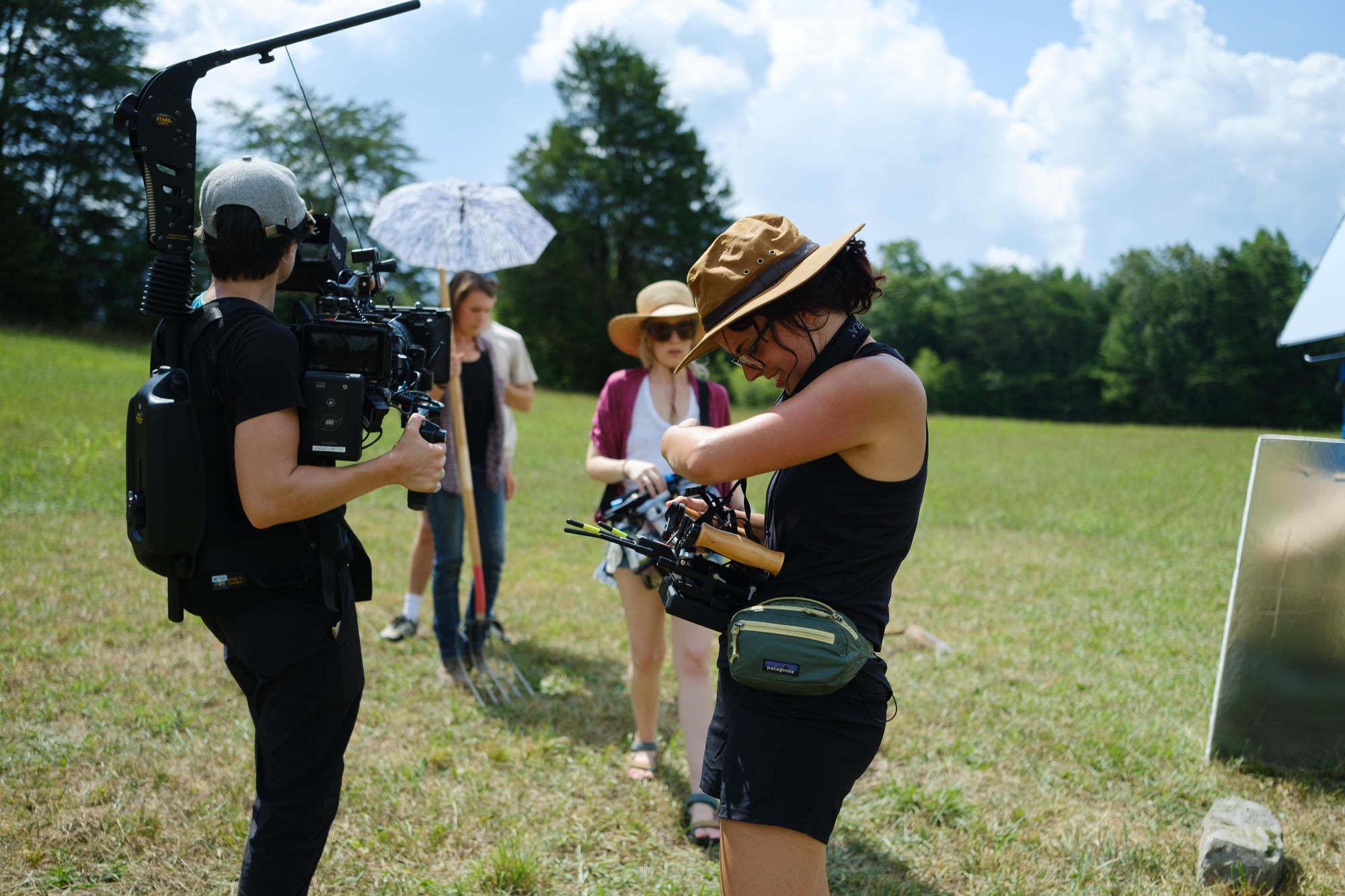 Rachael Porter checks a shot on her monitor in a grassy field