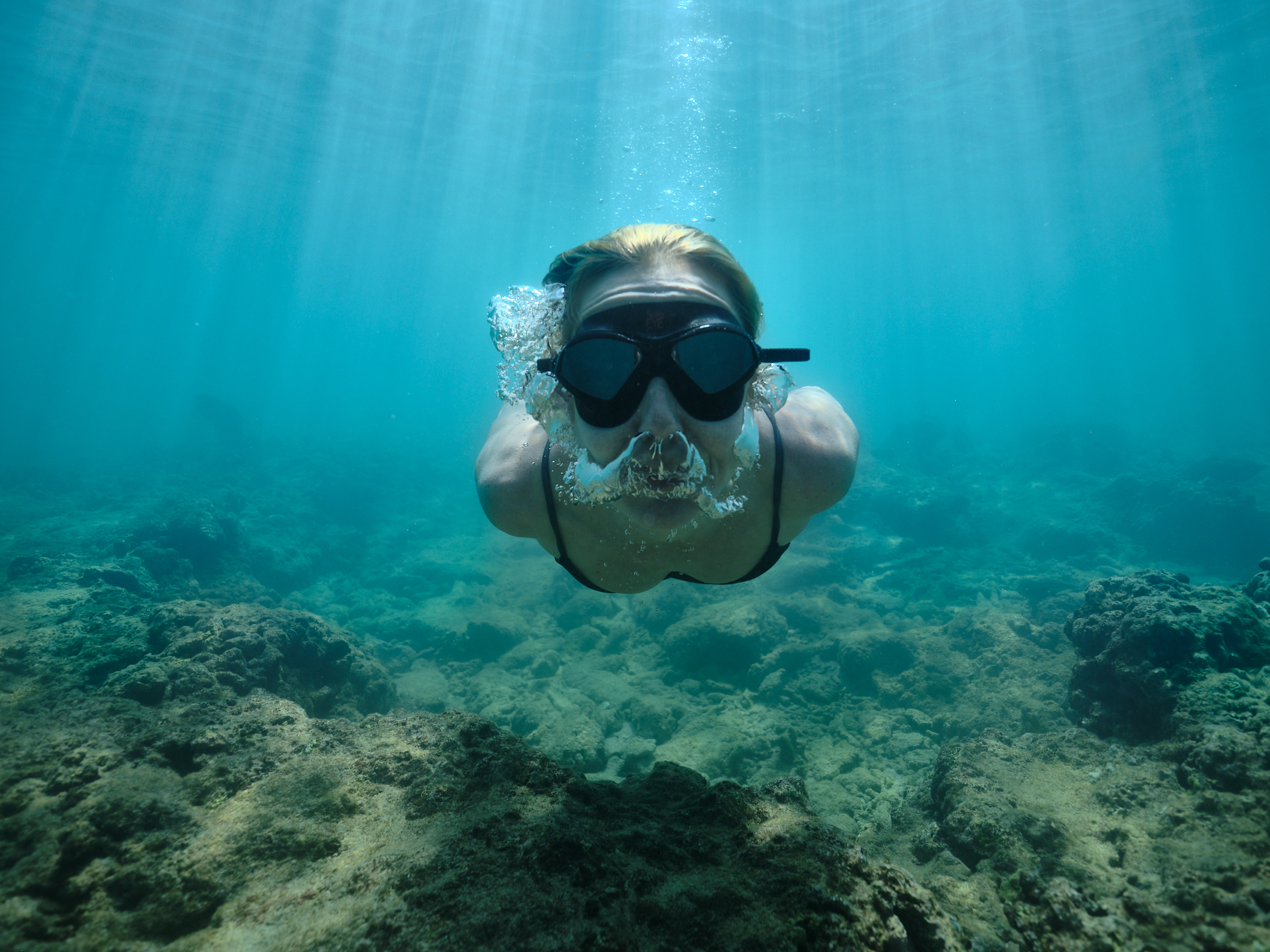 Person diving swimming towards camera