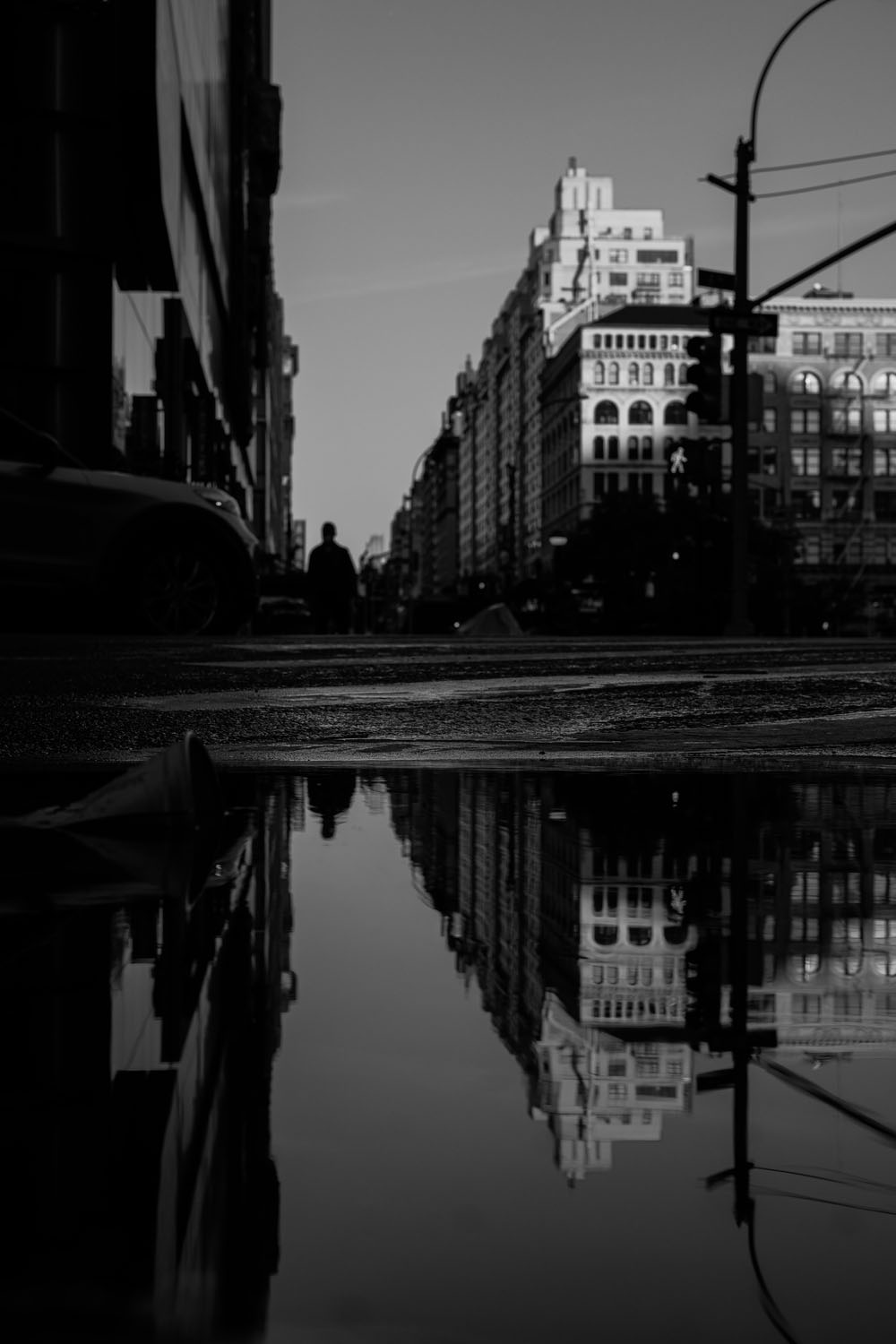 Reflection of city street in puddle