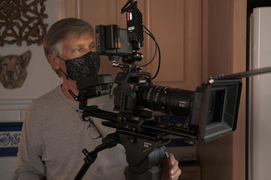 Michael Bulbenko operating FUJIFILM X-H2S movie camera rig on tripod.