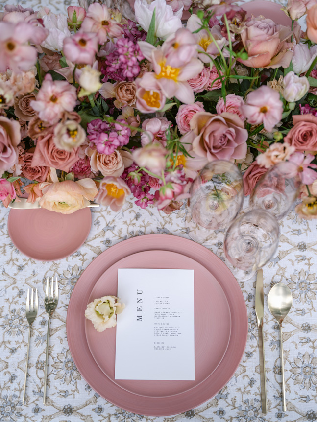 Close up of wedding place setting with pink and white accents