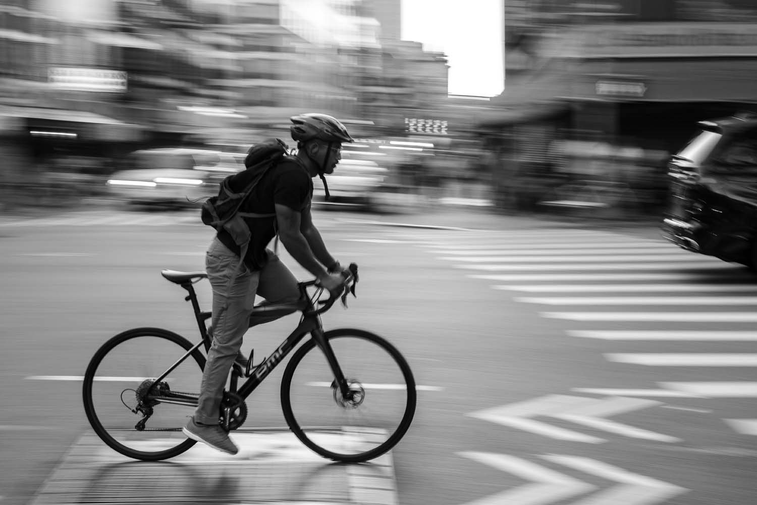 Man cycling in New York City traffic